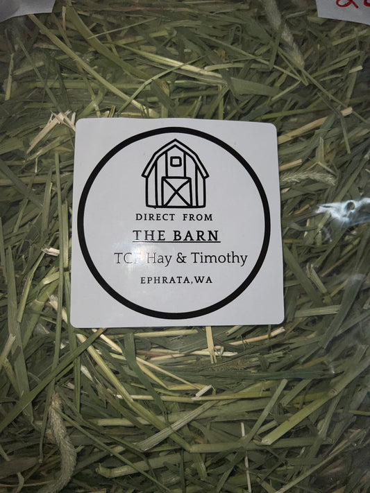 Close-up of bagged Timothy hay with label reading Direct From The Barn, TCF Hay & Timothy, Ephrata WA