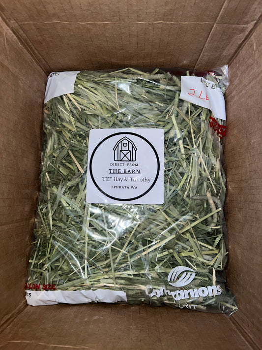 Bag of Timothy hay labeled 'Direct From The Barn' inside an open cardboard box